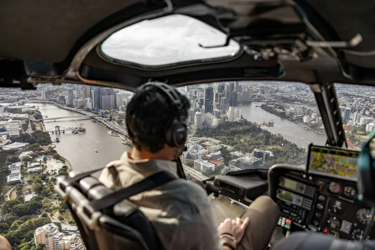 View over the Brisbane River and city from a helicopter cockpit